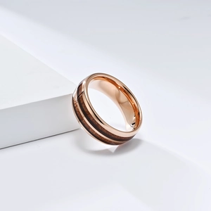 Detailed close-up of rose gold tungsten ring featuring double natural wood grain inlays
