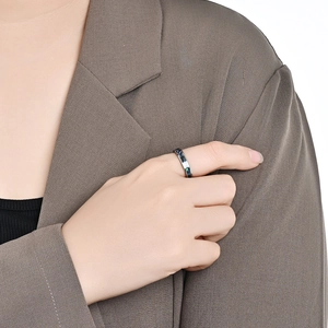 Polished tungsten ring with colorful abalone shell inlay shown on model index finger