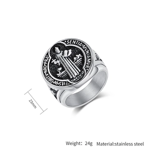 Macro detail of vintage Saint Benedict medal ring in silver stainless steel with carvings