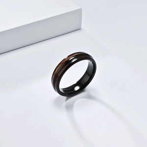 Detail of 8mm black polished tungsten ring featuring a natural wood grain inlay design