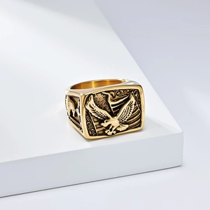 Close-up of golden eagle signet ring featuring American flag relief and vintage finish