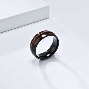 Polished black tungsten ring featuring double wood grain inlay bands on white background