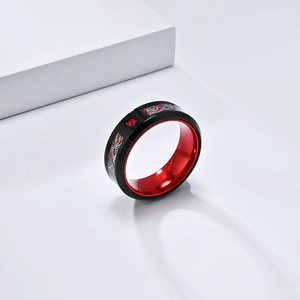 Detail shot of black stainless steel dragon ring with red alumina inlay on white block