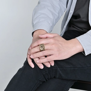 Men's vintage golden eagle signet ring with detailed relief on model's hand