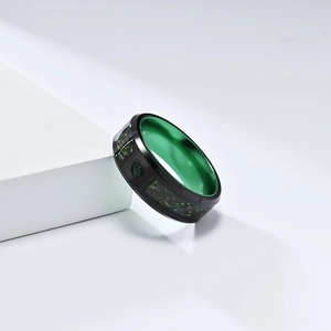 Men's black stainless steel ring with vibrant green inner band and inlaid gem detail