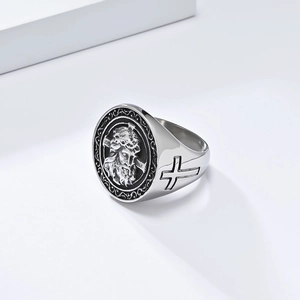 Detailed view of religious cross ring with Jesus portrait carving and silver finish
