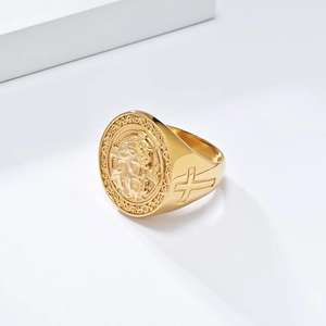 Detailed macro of gold signet ring featuring religious relief and side cross engraving