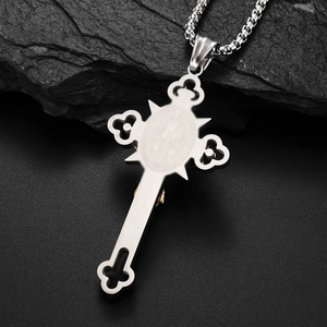Detail of vintage punk silver cross necklace with golden Jesus motif on black stone