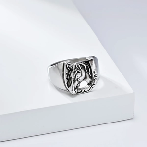 Detailed relief of a horseshoe and horse head on a vintage stainless steel ring