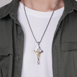 Retro vintage stainless steel cross pendant necklace worn by male model on green shirt