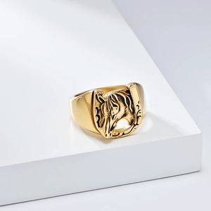 Detailed relief of golden horseshoe and horse head on vintage stainless steel ring