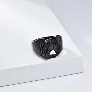 Macro detail of matte black stainless steel ring with embossed horse head and horseshoe