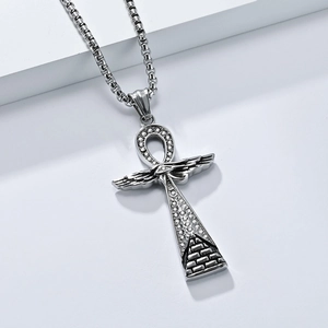 Detailed macro view of silver Ankh cross pendant with Horus eye and crystal inlay