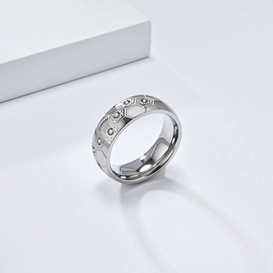 Macro detail of silver stainless steel ring with hexagonal patterns and inlaid zircons