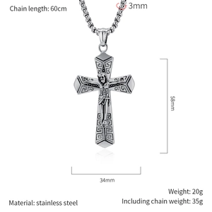 Detailed view of silver stainless steel cross pendant with retro relief on a box chain