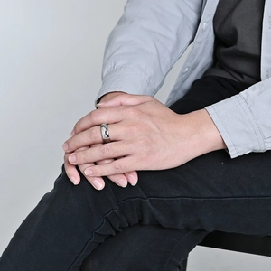 Men's stainless steel football ring with silver hexagonal honeycomb texture on finger