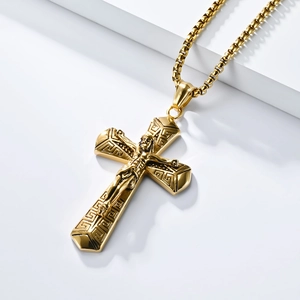 Close-up of golden stainless steel cross pendant with Greek key pattern and box chain detail