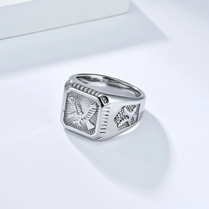 Detailed view of silver eagle signet ring with sunburst and geometric side textures