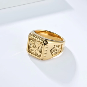 Macro detail of 18K gold eagle signet ring showing intricate engraving and polished texture
