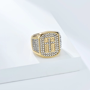 Macro shot of hip hop cross ring featuring iced-out zircon stones on golden plating