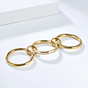 Detalle de anillos triples entrelazados chapados en oro con incrustaciones de circón