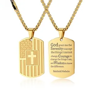 Detail of gold dog tag pendant showing US flag cross and engraved Serenity Prayer