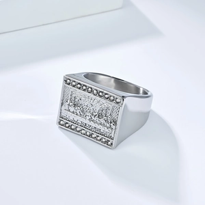 Macro shot of The Last Supper engraving on silver-toned stainless steel ring with zircons