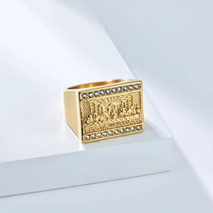 Macro detail of Last Supper engraving on 18K gold plated ring with zircon side stones