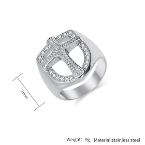 Close-up of a silver stainless steel shield ring with hollow cross and white zircon stones