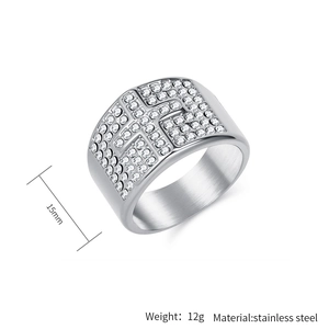 Macro detail of silver stainless steel cross ring with white zircon stones and 15mm width