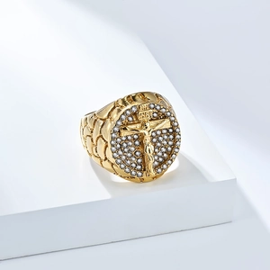 Macro detail of 18K gold plated cross ring featuring Jesus relief and sparkling crystals