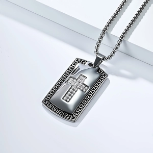 Detail of cross dog tag pendant with sparkling cubic zirconia and Greek key border