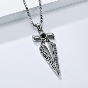 Macro shot of Viking rune sword pendant in titanium steel with black gemstone