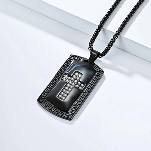 Detail macro view of black stainless steel cross pendant with Greek meander pattern