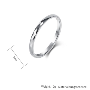 Detailed macro view of a 2mm silver tungsten ring with a faceted diamond-cut pattern