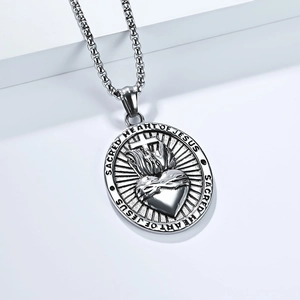 Macro view of vintage Sacred Heart of Jesus stainless steel cross pendant and box chain
