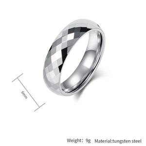 Macro detail of a 6mm faceted tungsten steel ring with a geometric diamond-cut design