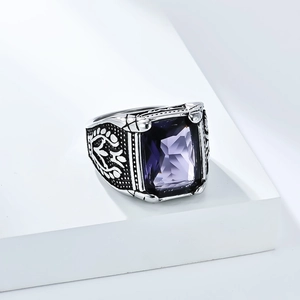 Detailansicht eines Vintage-Rings mit lila Edelstein und floralen Gravuren