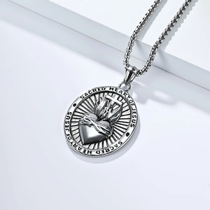 Macro shot of silver Sacred Heart of Jesus oval pendant necklace with steel pearl chain