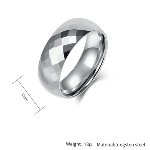 Macro detail of 8mm tungsten steel ring featuring a geometric diamond-cut faceted surface