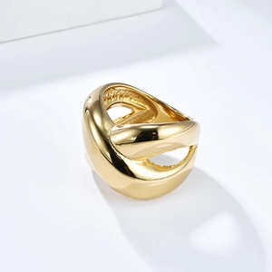 Macro shot of polished 18K gold plated stainless steel ring with interlaced design