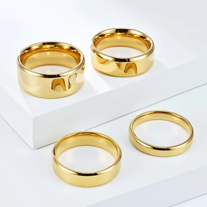 Polished gold titanium steel rings in four widths on a white geometric stand