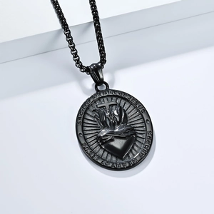 Detail of black stainless steel Sacred Heart of Jesus oval pendant with cross engraving