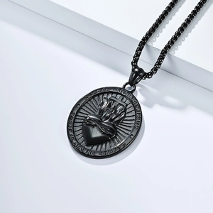 Macro shot of black vintage Sacred Heart of Jesus religious pendant on white steps