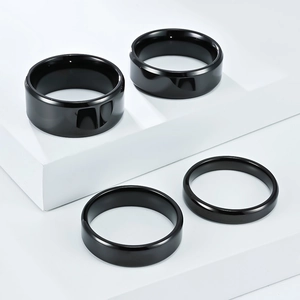 Polished black minimalist unisex ring set featuring four pieces with glossy beveled edges