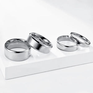 Polished silver stainless steel rings in four widths on white professional display stand