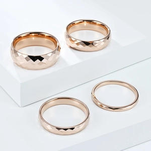 Detailed view of rose gold tungsten rings with faceted diamond-cut geometric surfaces