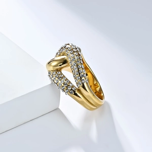 18K gold plated knot ring with sparkling micro-paved rhinestones on a white pedestal