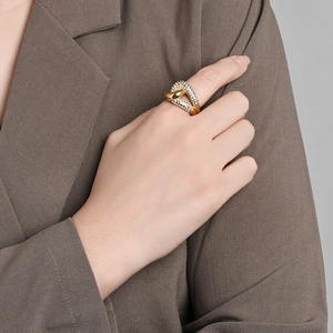 Elegant 18K gold plated titanium steel knot ring with sparkling crystals on model