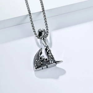Macro detail of vintage steel axe pendant with engraved Viking Valknut symbol on metal surface